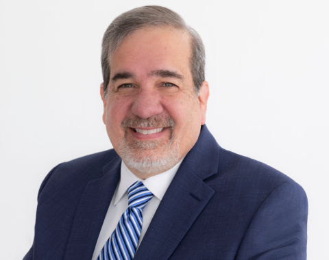 a headshot of tom trahan smiling